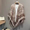 Detail view of the beige paisley print shawl scarf with fringe hem, elegant styling prop. - Khaki Paisley