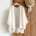 Detailed view of white lace chiffon cardigan, lightweight beach cover up with delicate floral trim. - Off White