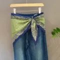 Stylish women's blue denim jeans paired with a versatile green printed silk scarf waistband. - 30#