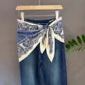 Blue denim jeans featuring a stylish blue and white paisley print scarf tied at the waist. - 11#