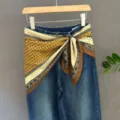 Blue denim jeans featuring yellow patterned scarf waist tie, stylish casual variant. - 23#