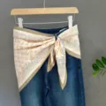 Beige paisley silk scarf styled as a waist belt on blue denim jeans, versatile accessory. - 16#
