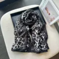 Detail shot of black and white leopard print linen scarf draped neatly in tray. - Black White Grey Leopard