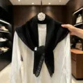 Black knitted triangular scarf with fringe, stylish shawl wrap for women, cozy winter accessory. - Black