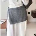 Grey hollow knit wrap skirt waist accessory detail showing texture and side tie design. - Gray