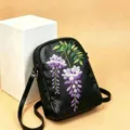 Black leather crossbody shoulder bag featuring elegant purple wisteria embroidery design chic - Wisteria Flower