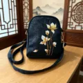 Elegant black crossbody bag with traditional Chinese floral embroidery and gold hardware. - Single Outstanding Flower