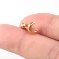 Goldfarbener Edelstahl Mond Knorpel Piercing Detailaufnahme, zeigt das zarte Halbmonddesign. - Gold