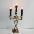 Halloween skeleton candle holder with LED electronic flickering flame candles for spooky decor. - Red Triple Candles