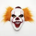 Scary clown mask detail showing white face paint, red makeup, and vibrant orange synthetic hair. - Horror Clown Mask with Hair