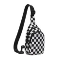 Details of the black and white checkerboard sling chest bag with adjustable strap. - Black and White