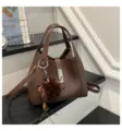 Brown litchi pattern leather bucket bag for women, stylish handbag with metal lock and charm. - With Pendant / Coffee