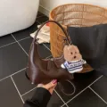 Retro brown crescent shoulder bag for women, trendy PU leather hobo handbag with cute plush bear. - With Pendant / Coffee