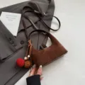 Brown suede dumpling bag for women, retro shoulder crossbody bag with cute pom pom charms. - With Pendant / Coffee