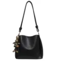 Black bucket shoulder bag with knotted strap and cute bunny pendant for autumn commute. - With Pendant / Black