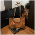 Stylish brown suede tote bag with long straps, flap closure, and cute pom-pom pendant. - With Pendant / Brown