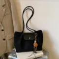 Stylish black suede tote bag with double straps and leather flap for women daily commute. - With Pendant / Black