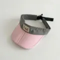 Detail view of a stylish color-block kids sun visor, featuring a pink brim and adjustable strap. - 48-52cm / Light Pink Brim
