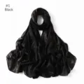 Close-up detail of black shimmering gold glitter chiffon hijab scarf, soft fabric texture. - Black