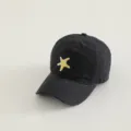 Black children's baseball cap detail showing cute yellow starfish embroidery design. - Black