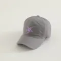 Close-up detail of grey kids baseball hat with purple embroidered starfish pattern, soft fabric. - Gray