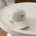Detailed view of children beige baseball cap with Good letter embroidery and distressed brim. - 54cm Adjustable For 6-12 Years / Smile Good White