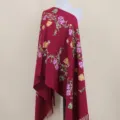 Burgundy cashmere-feel scarf with intricate floral vine embroidery and elegant fringe details. - Burgundy