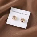Close-up detail of the round gold magnetic hijab pin set, showing polished finish. - COL.22 Gold