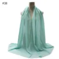 Close-up detail of the lightweight mint green pearl chiffon hijab and scarf fabric texture. - #38 Pattern
