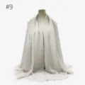Solid color crinkled hijab scarf detail view, lightweight texture, elegant draped fringe style. - Style #9