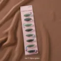 Detail view of green plastic safety hijab pins card pack, secure scarf clips for daily wear. - 8 Pieces/Pack / Green Set