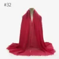 Detail view of the red crinkled scarf showing textured fabric and delicate fringe edges. - #32