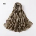 Detailed view of the shimmering metallic viscose scarf with short fringe ends in elegant gold. - Gold Khaki