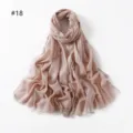 Detailed view of the sparkling metallic viscose scarf with short fringe ends for women. - Soft Pink