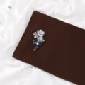 Rhinestone flower brooch detail, sparkling crystal embellishment on elegant brown fabric. - Size 7 / 1.8m