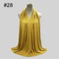 Detailed view of yellow solid color modal hijab scarf draped gracefully on mannequin. - No.28 Yellow