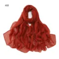 Detailed view of rust orange rhinestone embellished sheer long scarf, elegant fabric texture. - Brick Red