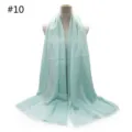 Mint green breathable cotton scarf detail, featuring delicate tassel fringe and soft fabric texture. - Style #10
