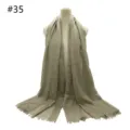 Detail of a breathable solid color cotton blend scarf featuring short fringe and oversized design. - #35