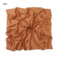 Detail shot of a lightweight chiffon square scarf in solid caramel brown color, soft and airy. - #33 Paisley