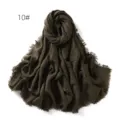 Close-up of dark green crinkled cotton linen scarf, frayed edges, breathable sun protection shawl. - Dark Green