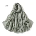 Detail view of light green linen gauze scarf shawl showing soft texture and fringe edge. - Light Green