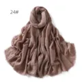 Close-up detail of the soft crinkled cotton linen scarf showing the delicate fringe edge. - Brown Coffee