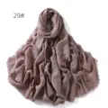 Detail view of the solid color crinkled linen hijab shawl with chic frayed edges for women. - Lotus Pink
