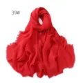 Detail view of the solid red cotton linen crinkled scarf with stylish frayed fringe edges. - Red