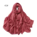Detail view of the crinkled cotton linen scarf texture, showing soft frayed fringe edges clearly. - Dark Pink