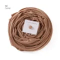 Detail view of the mercerized cotton long hijab scarf in camel with magnetic buckle set. - Camel