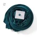 Teal hijab scarf with magnet pin detail, soft mercerized cotton texture, elegant wrapped presentation - Dark Cyan