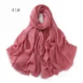 Close up detail of solid pink crinkled cotton linen scarf with fine tassel fringe edge. - Pink