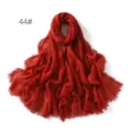Detailed view of the solid color crinkled cotton linen breathable fringe scarf shawl. - Brick Red